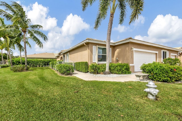 view of front of home with a front yard and a garage