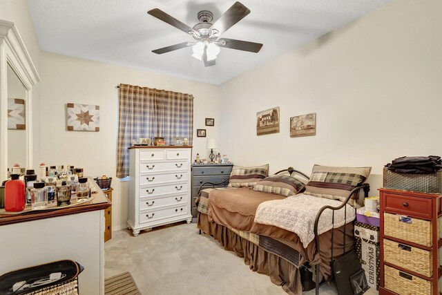 bedroom with light carpet and ceiling fan