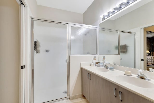 bathroom with vanity and a shower with door