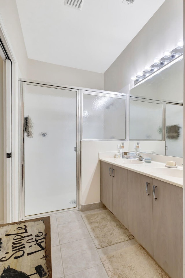 bathroom with vanity, tile patterned floors, and an enclosed shower