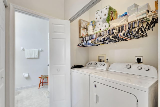 laundry room featuring light tile patterned flooring and washing machine and clothes dryer