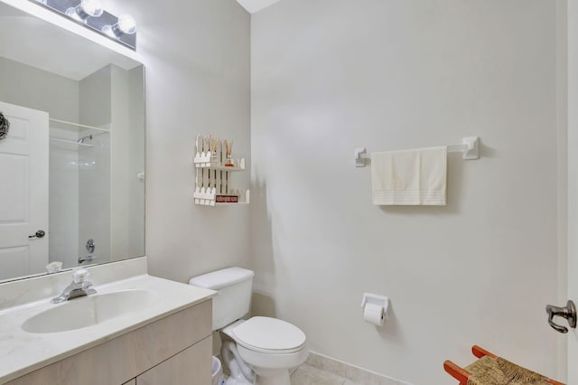 bathroom featuring vanity, tile patterned flooring, toilet, and walk in shower