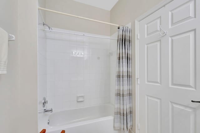 bathroom with shower / bath combo with shower curtain