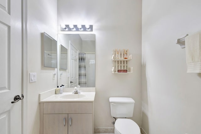 bathroom featuring toilet and vanity