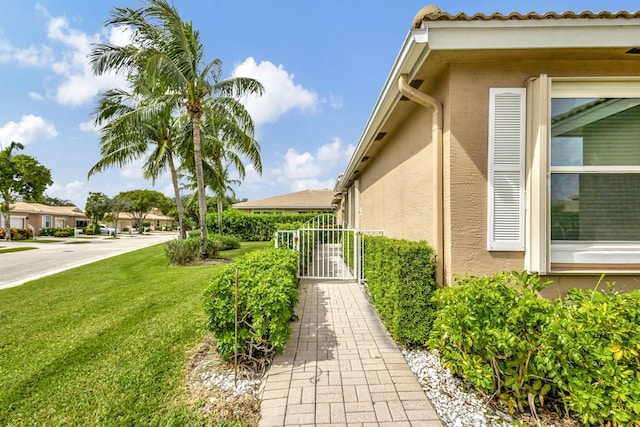 view of side of property with a lawn