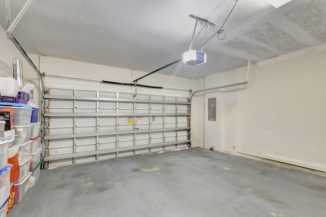 garage with a garage door opener and electric panel