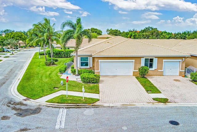 view of front of home with a garage and a front lawn