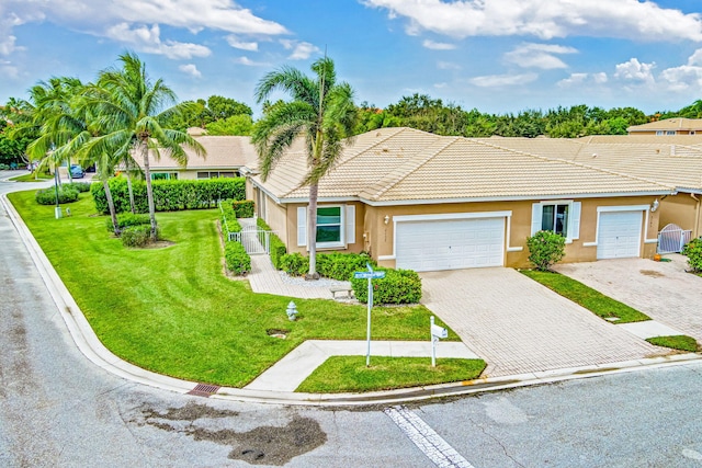 single story home featuring a front yard and a garage