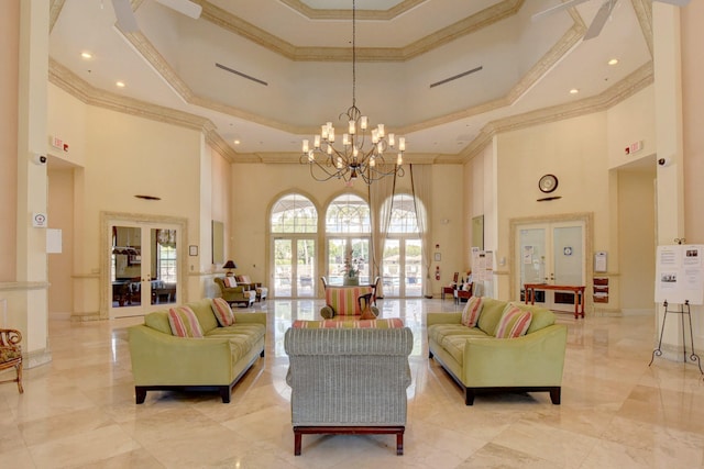 living room with a towering ceiling, french doors, and crown molding