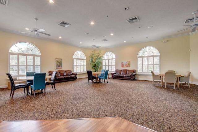 living room featuring ornamental molding, hardwood / wood-style floors, plenty of natural light, and ceiling fan