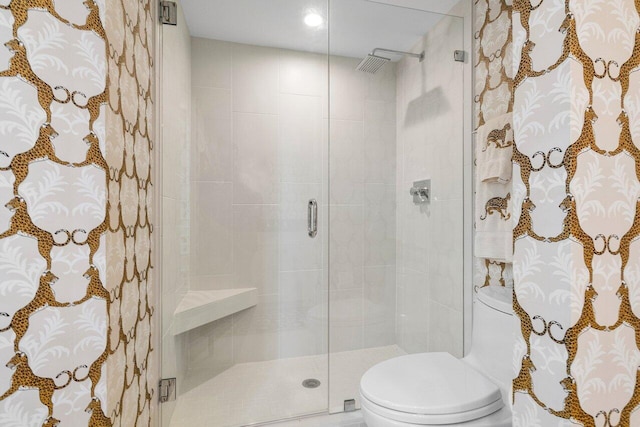 bathroom with toilet and an enclosed shower