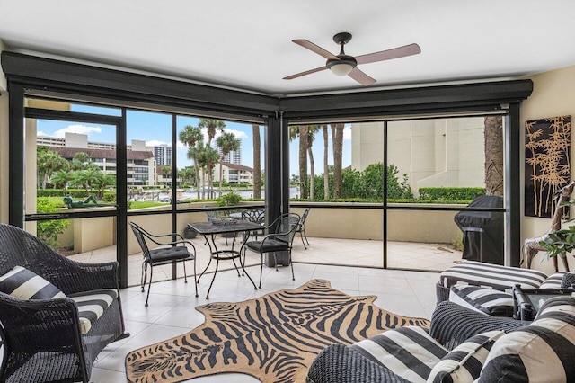 sunroom / solarium featuring ceiling fan