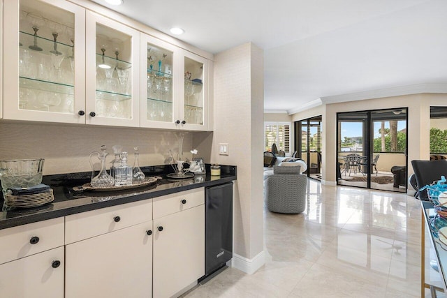 bar with crown molding, white cabinetry, dark stone countertops, and tasteful backsplash