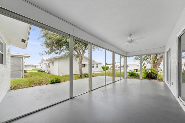 unfurnished sunroom with a healthy amount of sunlight and ceiling fan