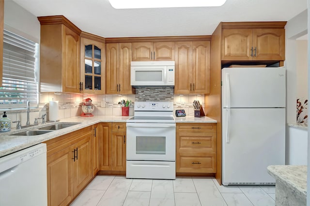 720 E Ocean Ave Unit 303, Boynton Beach, FL 33435 - kitchen with marble finish floor, a sink, white appliances, decorative backsplash, and glass insert cabinets