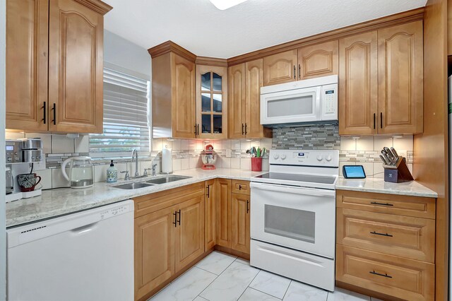 720 E Ocean Ave Unit 303, Boynton Beach, FL 33435 - kitchen with a sink, glass insert cabinets, white appliances, marble finish floor, and light stone counters