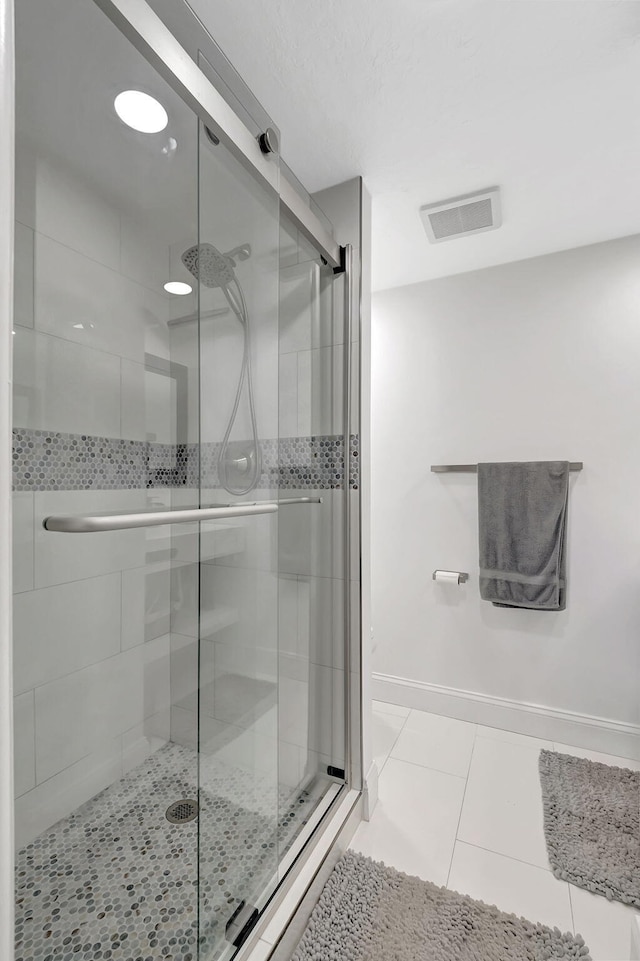 bathroom with tile patterned floors and walk in shower