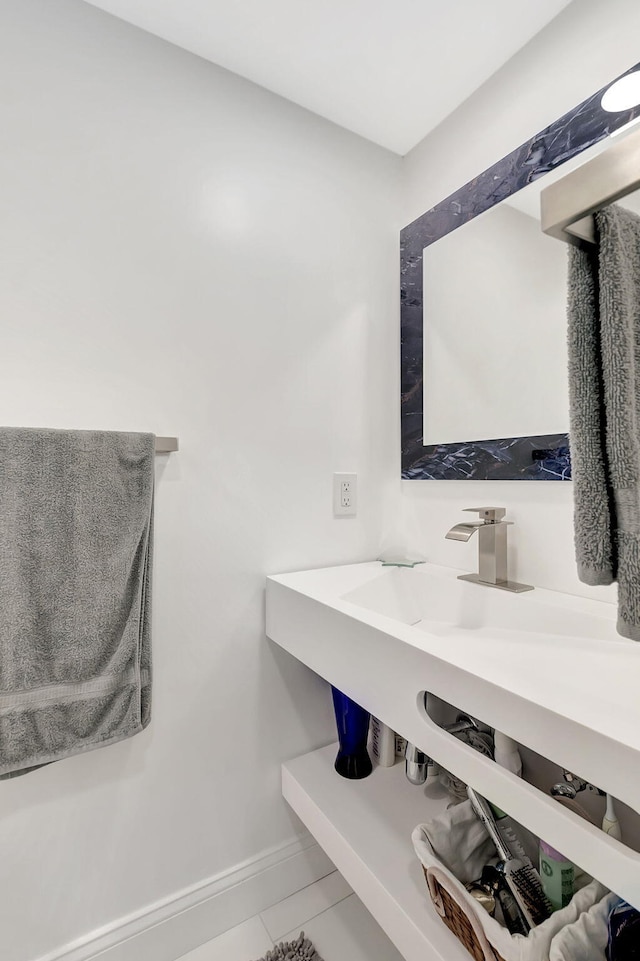 720 E Ocean Ave Unit 303, Boynton Beach, FL 33435 - bathroom featuring tile patterned flooring, baseboards, and a sink