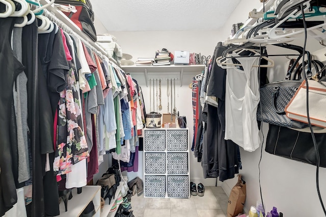 walk in closet with light tile patterned flooring