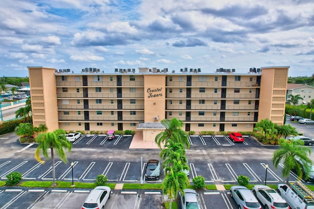 720 E Ocean Ave Unit 303, Boynton Beach, FL 33435 - view of building exterior with a city view and uncovered parking