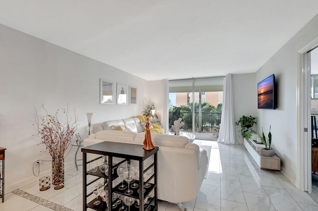 720 E Ocean Ave Unit 303, Boynton Beach, FL 33435 - living room featuring expansive windows, marble finish floor, and baseboards