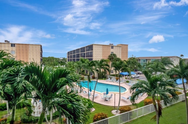 view of swimming pool featuring a patio and a lawn