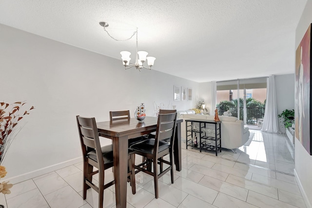 tiled dining area with an inviting chandelier and a textured ceiling