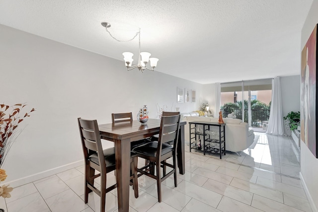 720 E Ocean Ave Unit 303, Boynton Beach, FL 33435 - dining space featuring a textured ceiling, baseboards, and a notable chandelier