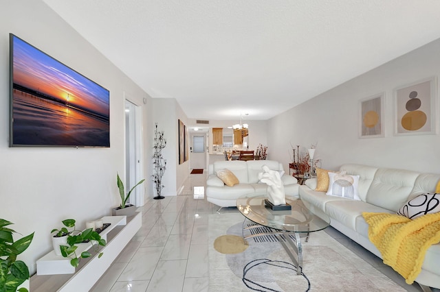 720 E Ocean Ave Unit 303, Boynton Beach, FL 33435 - living room with marble finish floor and an inviting chandelier