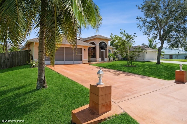 view of front of home with a front lawn and a garage