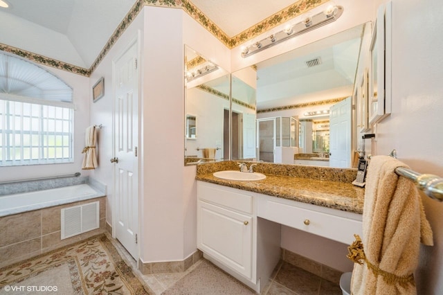 bathroom featuring vanity, vaulted ceiling, and separate shower and tub