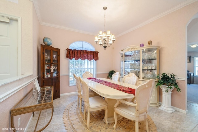 dining room featuring crown molding, a notable chandelier, a healthy amount of sunlight, and light tile patterned floors