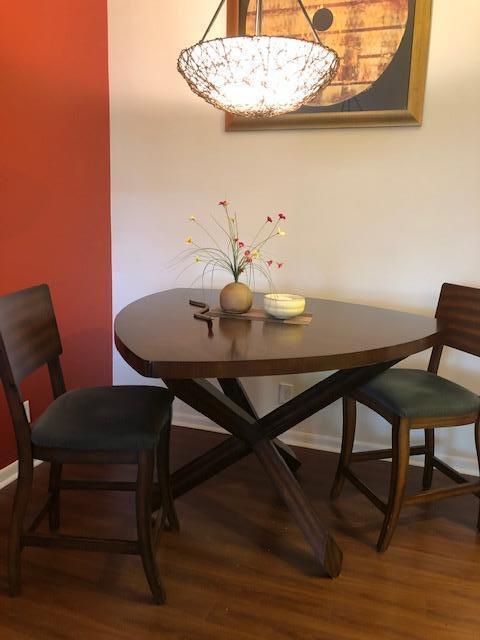 dining space featuring a notable chandelier and hardwood / wood-style flooring