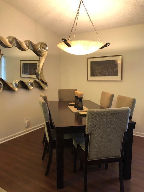 dining area with dark hardwood / wood-style flooring