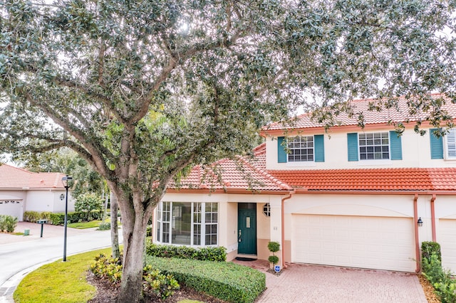 mediterranean / spanish-style home with a garage