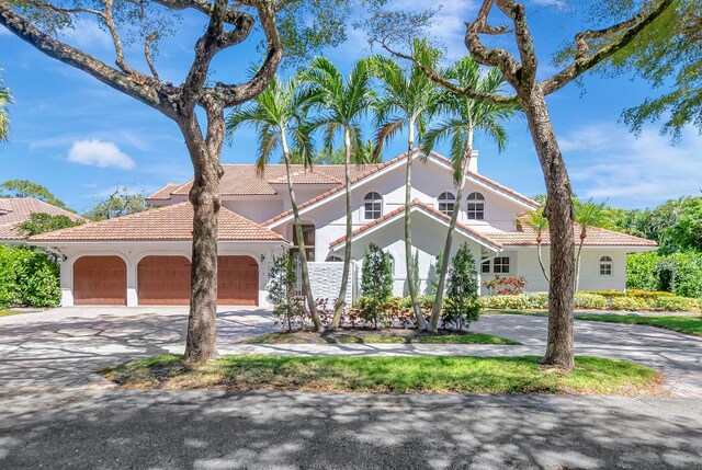 930 N Parkside Cir N, Boca Raton, FL 33486 - mediterranean / spanish-style home featuring stucco siding, driveway, an attached garage, and a tiled roof