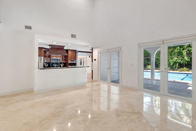 930 N Parkside Cir N, Boca Raton, FL 33486 - unfurnished living room featuring washer / dryer, french doors, visible vents, and marble finish floor