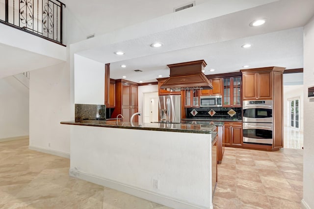 930 N Parkside Cir N, Boca Raton, FL 33486 - kitchen featuring visible vents, brown cabinets, island exhaust hood, appliances with stainless steel finishes, and a peninsula