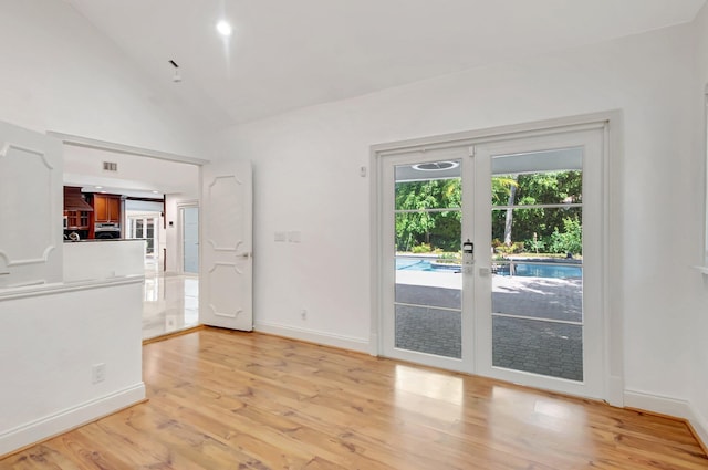 930 N Parkside Cir N, Boca Raton, FL 33486 - empty room with light wood finished floors, french doors, baseboards, and vaulted ceiling