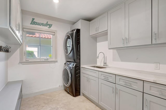930 N Parkside Cir N, Boca Raton, FL 33486 - clothes washing area featuring cabinet space, stacked washer / drying machine, baseboards, and a sink