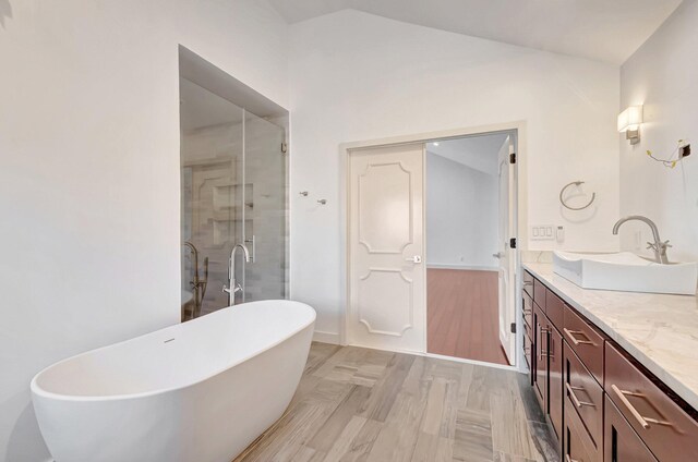 930 N Parkside Cir N, Boca Raton, FL 33486 - bathroom with a stall shower, a sink, double vanity, a freestanding bath, and vaulted ceiling