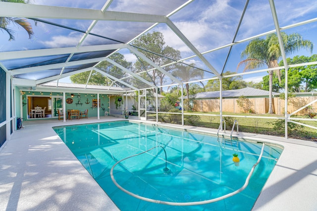 view of pool featuring a patio area, a lanai, and ceiling fan