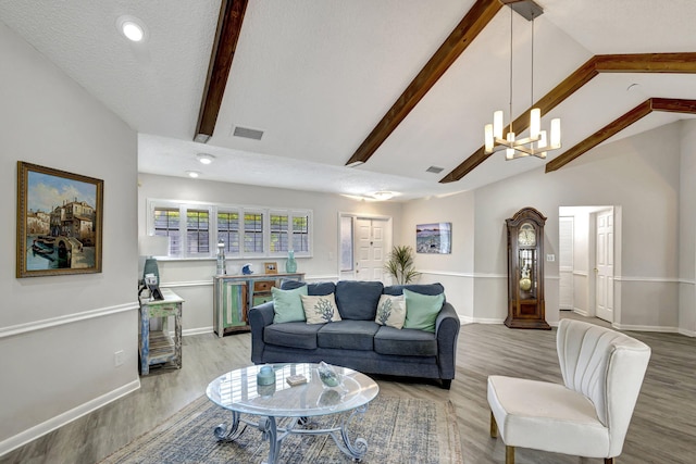 living room featuring a textured ceiling, light hardwood / wood-style flooring, and a chandelier