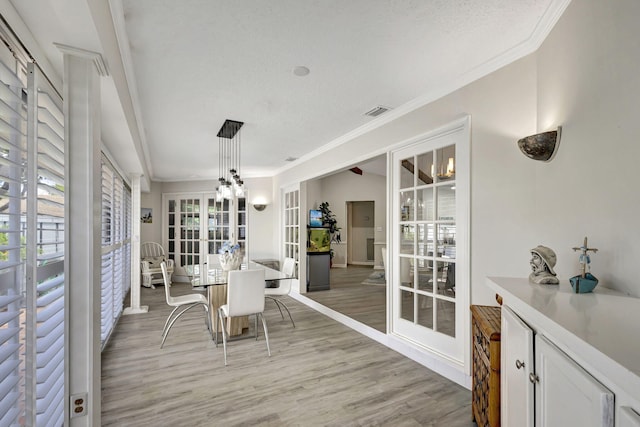 sunroom / solarium featuring french doors