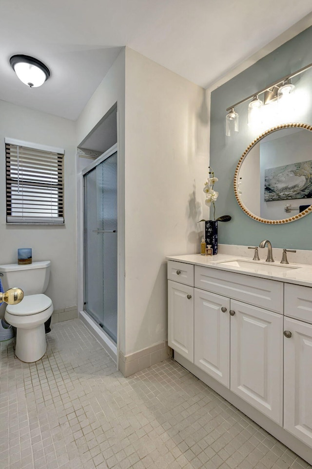 bathroom with vanity, walk in shower, toilet, and tile patterned flooring