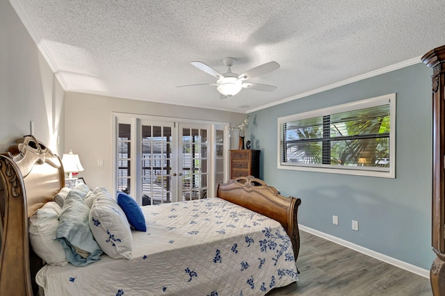 bedroom with a textured ceiling, hardwood / wood-style flooring, multiple windows, and ceiling fan