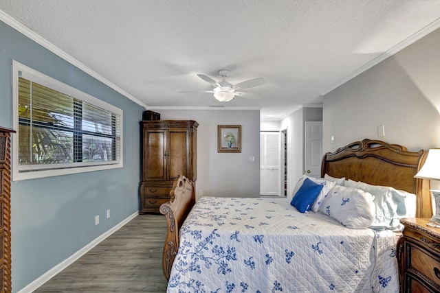 bedroom with ceiling fan, ornamental molding, a textured ceiling, and hardwood / wood-style floors