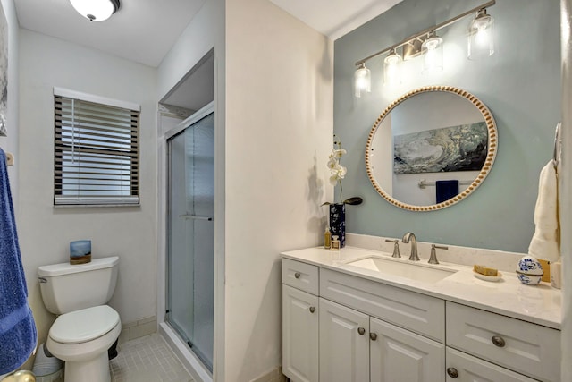 bathroom featuring toilet, an enclosed shower, vanity, and tile patterned floors