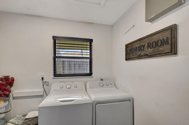 clothes washing area with washer and clothes dryer