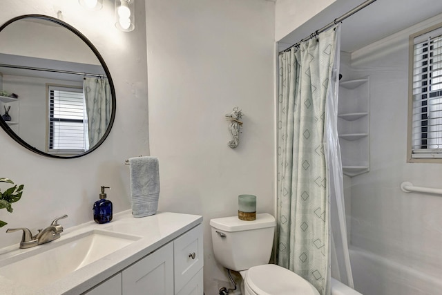 full bathroom with vanity, shower / tub combo with curtain, and toilet